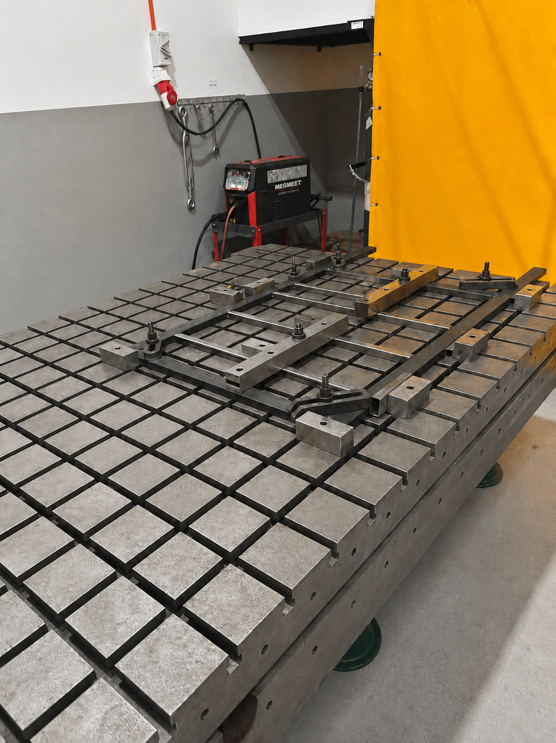 KLH frame components fixtured on a welding table
